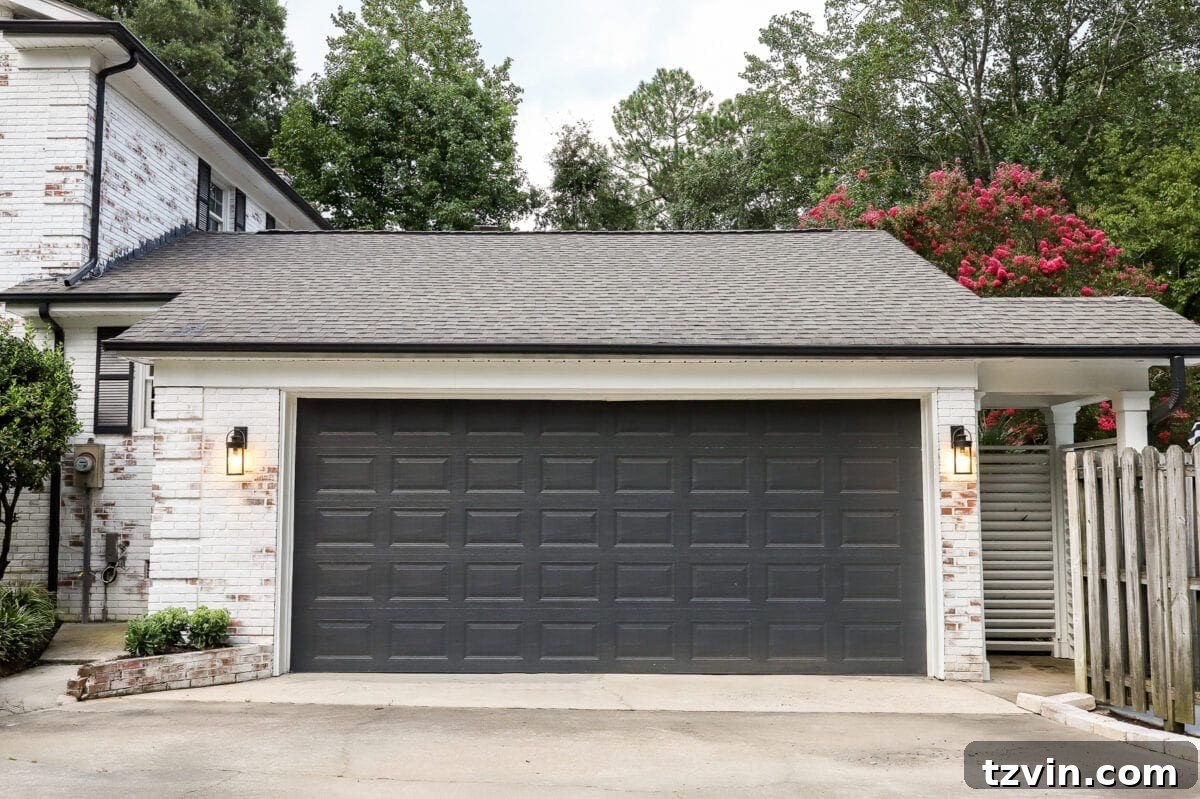 Transformed garage exterior with a newly painted black garage door.