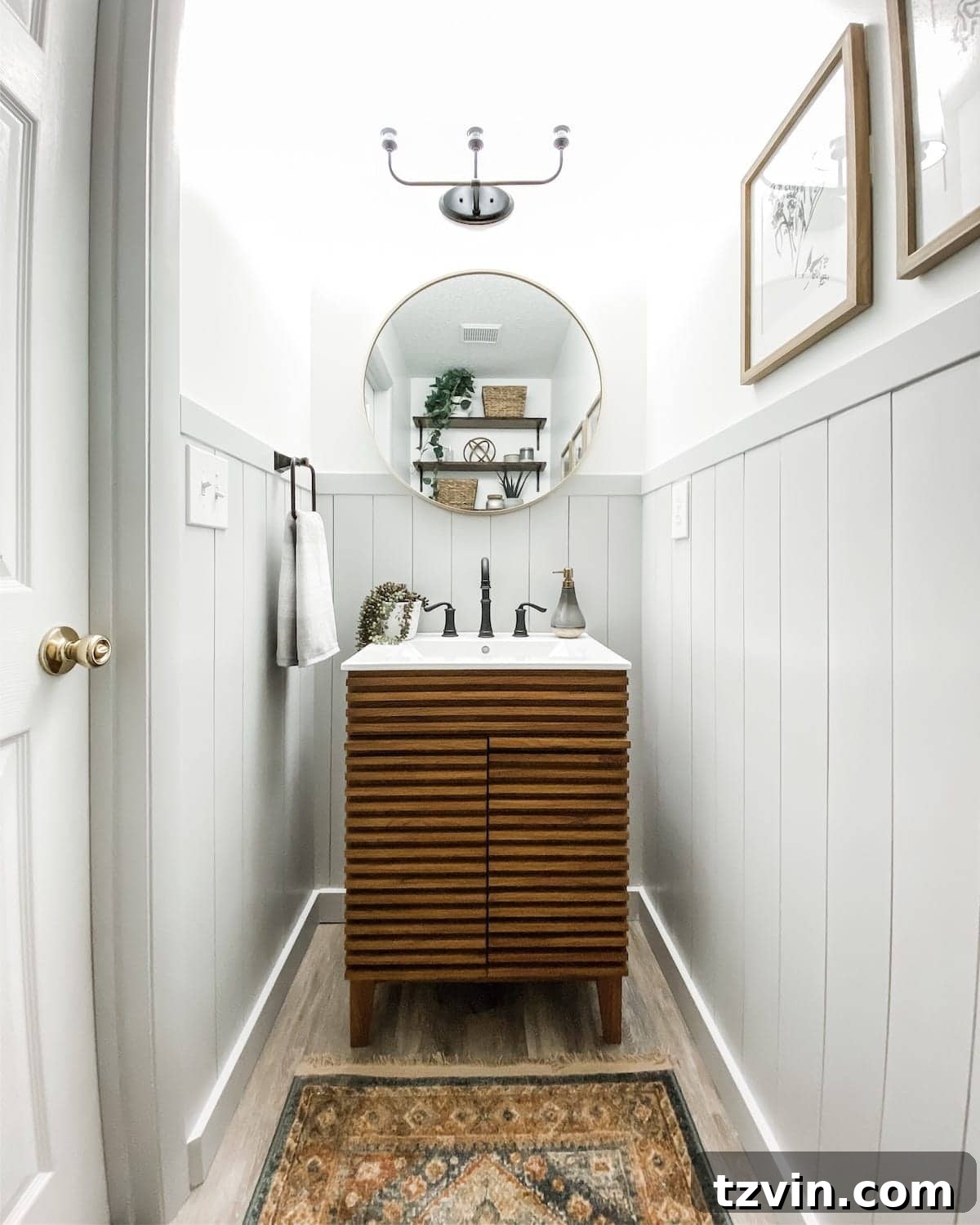 Small powder room with vertical shiplap and Mid Century Modern style vanity, showcasing the transformation