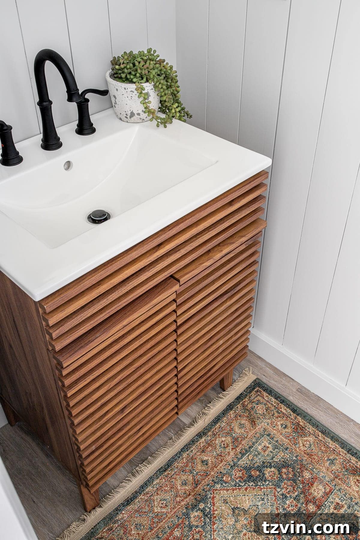 Close-up of the Mid Century Modern sink vanity and vintage style rug in the refreshed powder room
