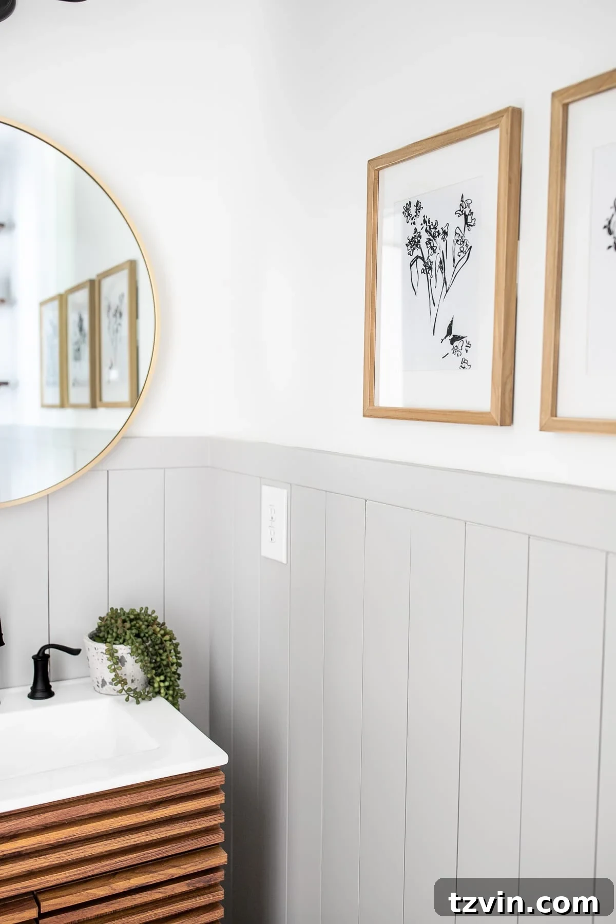 California Casual modern powder room with minimalist botanical art prints and round mirror
