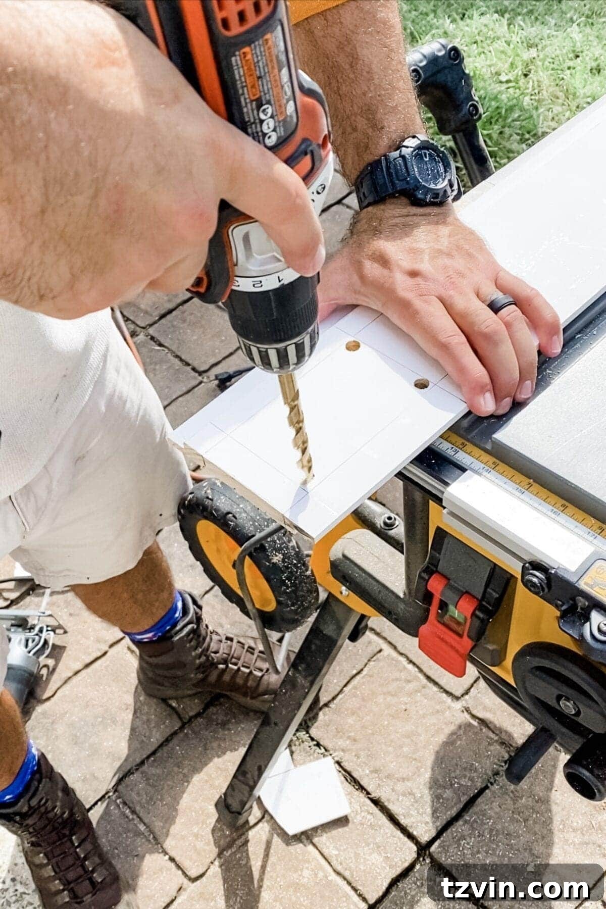 A close-up of a shiplap board showing four pilot holes drilled at the corners of a traced rectangle, ready for a jigsaw to cut out an opening.