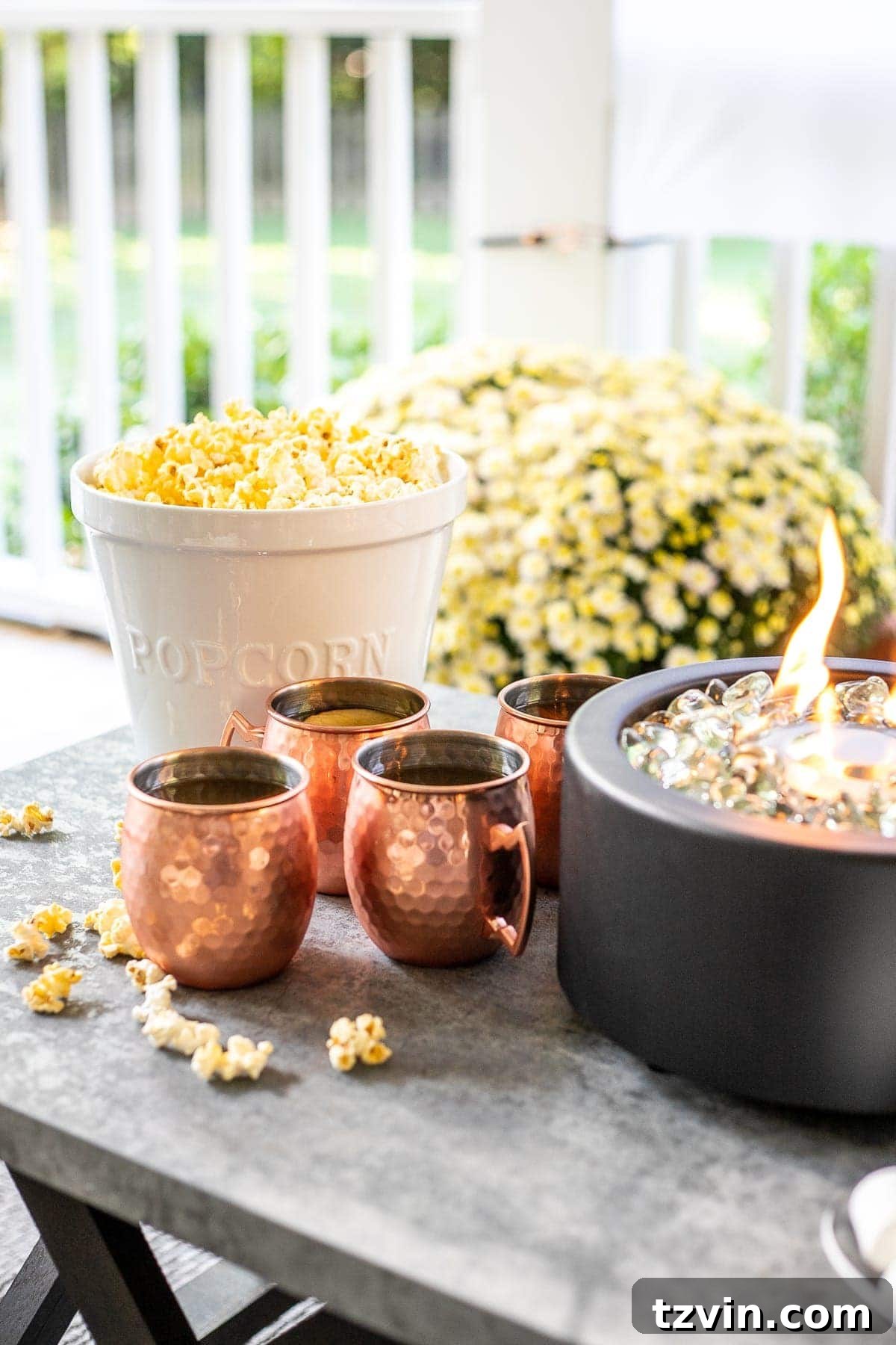 Fall Porch Magic: DIY Outdoor Movie Nights and Smores Bar 8 Copper mugs, popcorn, and fire bowl on s'mores table