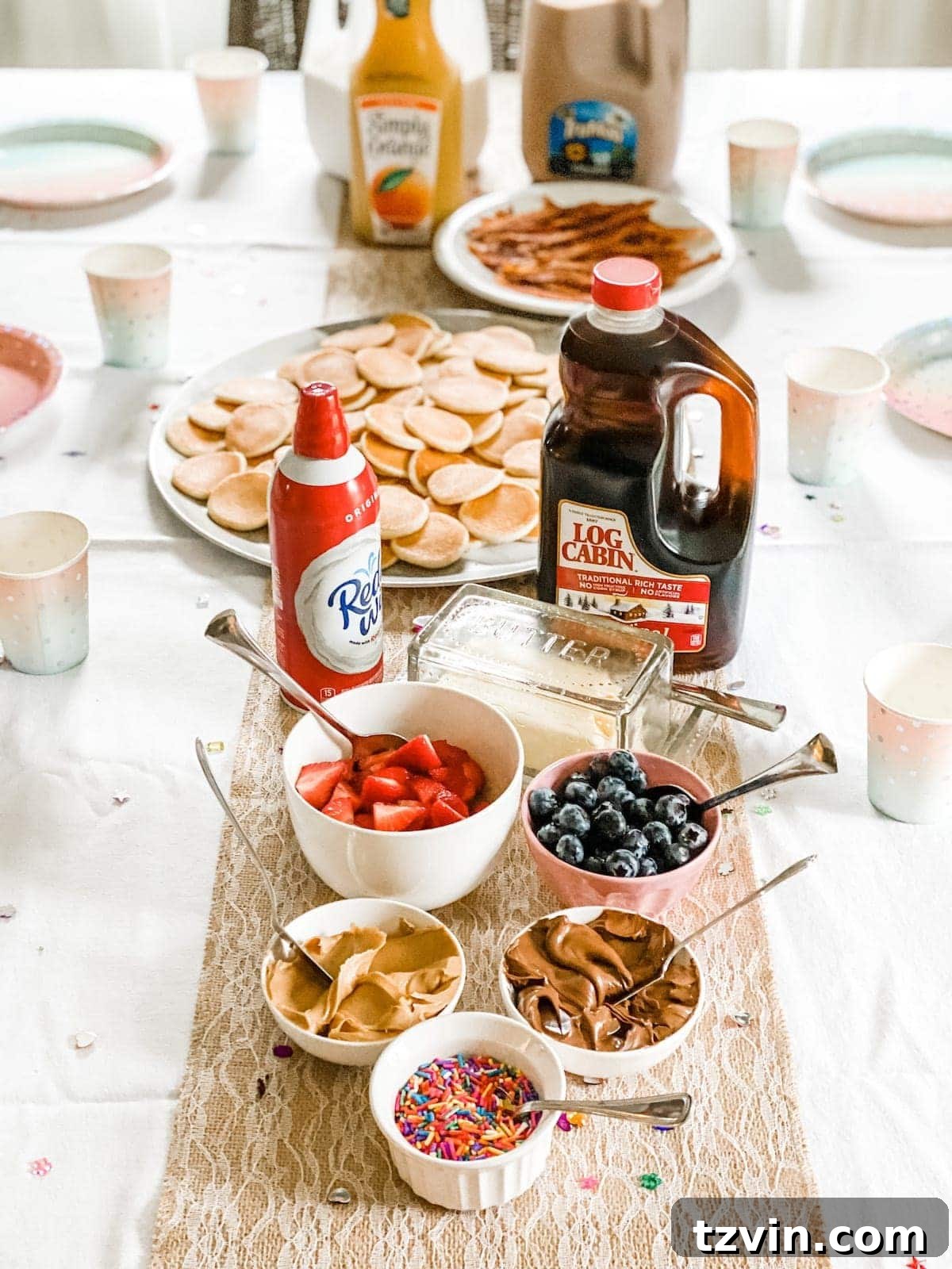 Elevate Small Group Sleepovers With Walmart Plus 11 Kids decorating pancakes with various toppings at a DIY pancake bar for breakfast