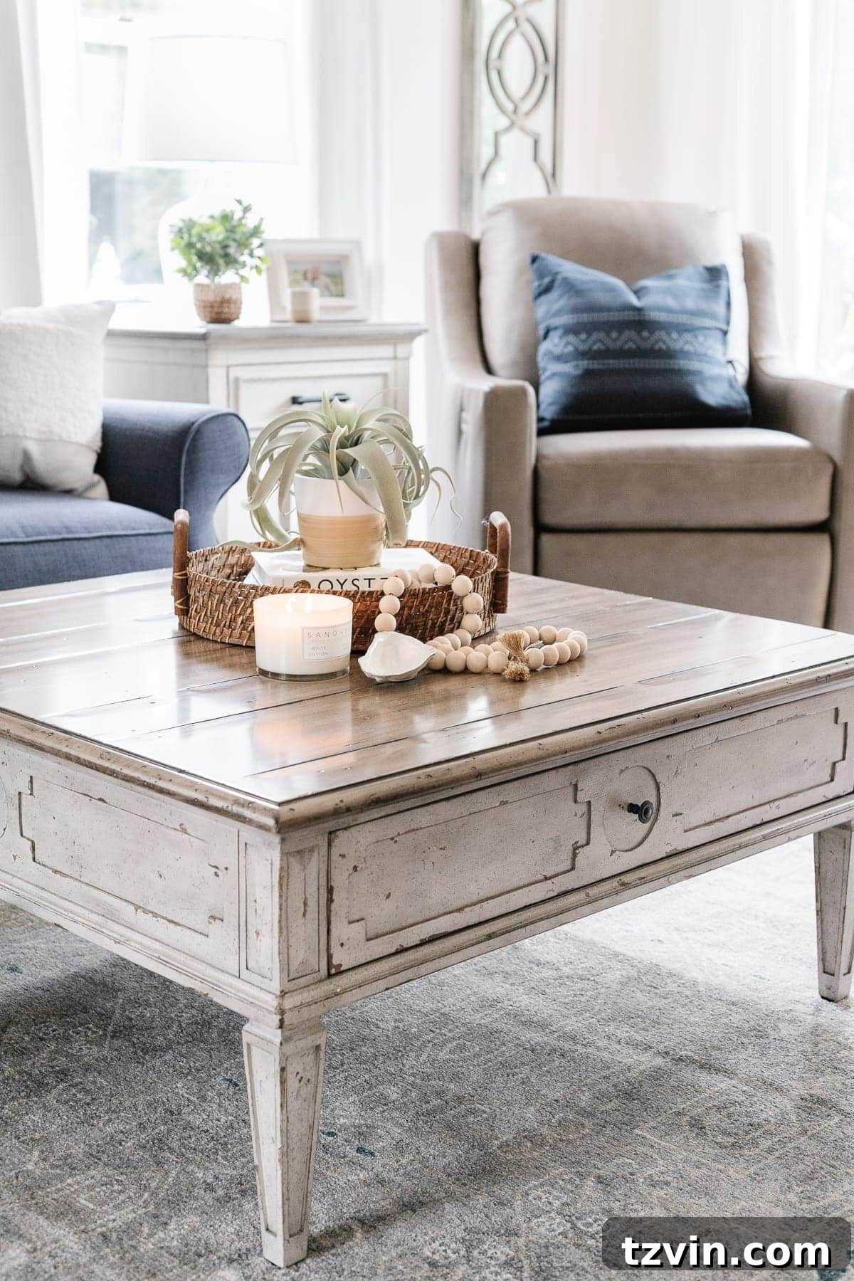 McNay Project Modern Coastal Living Room Tour 12 Verona coffee table with rustic texture and Bella side table with charging capabilities, complementing the Bassett furniture.