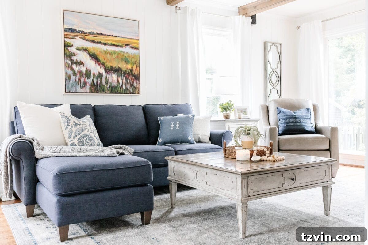 McNay Project Modern Coastal Living Room Tour 13 Living room showcasing the navy sofa, marsh painting, and a gray and blue area rug.