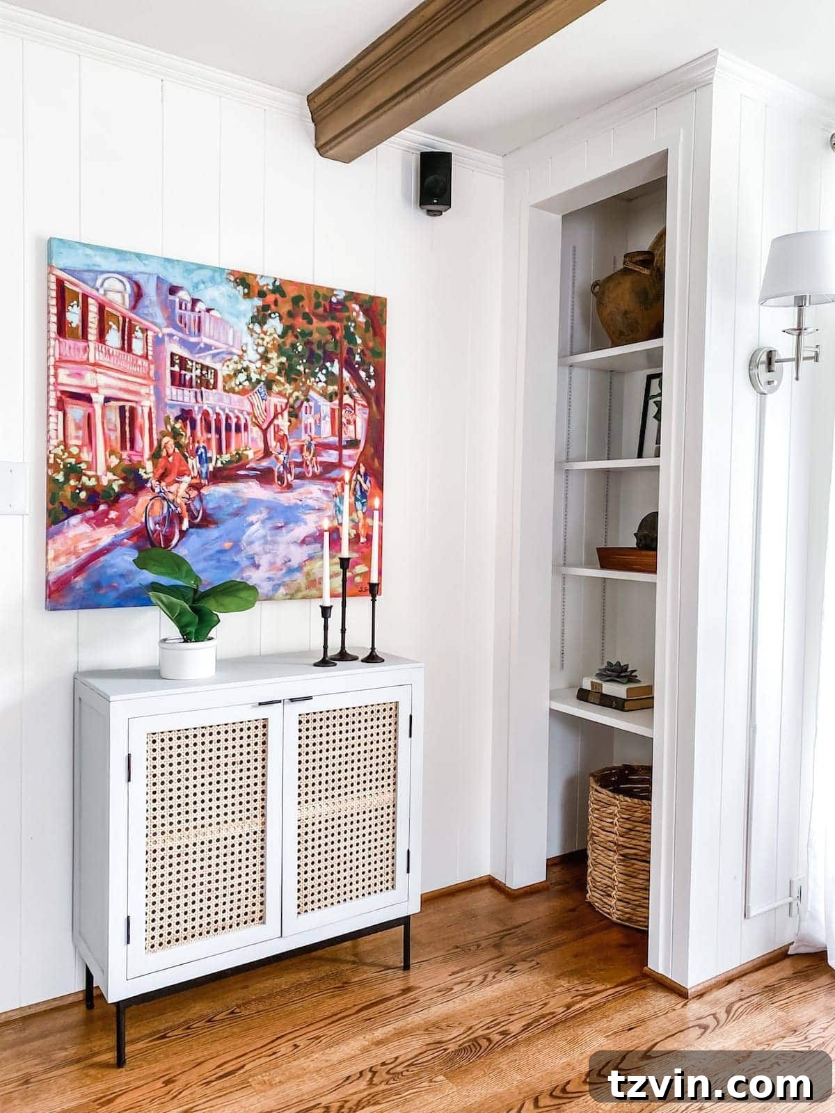 McNay Project Modern Coastal Living Room Tour 16 Accent cabinet painted in Fusion Mineral Paint Sterling with a vibrant painting above, part of the new workspace.