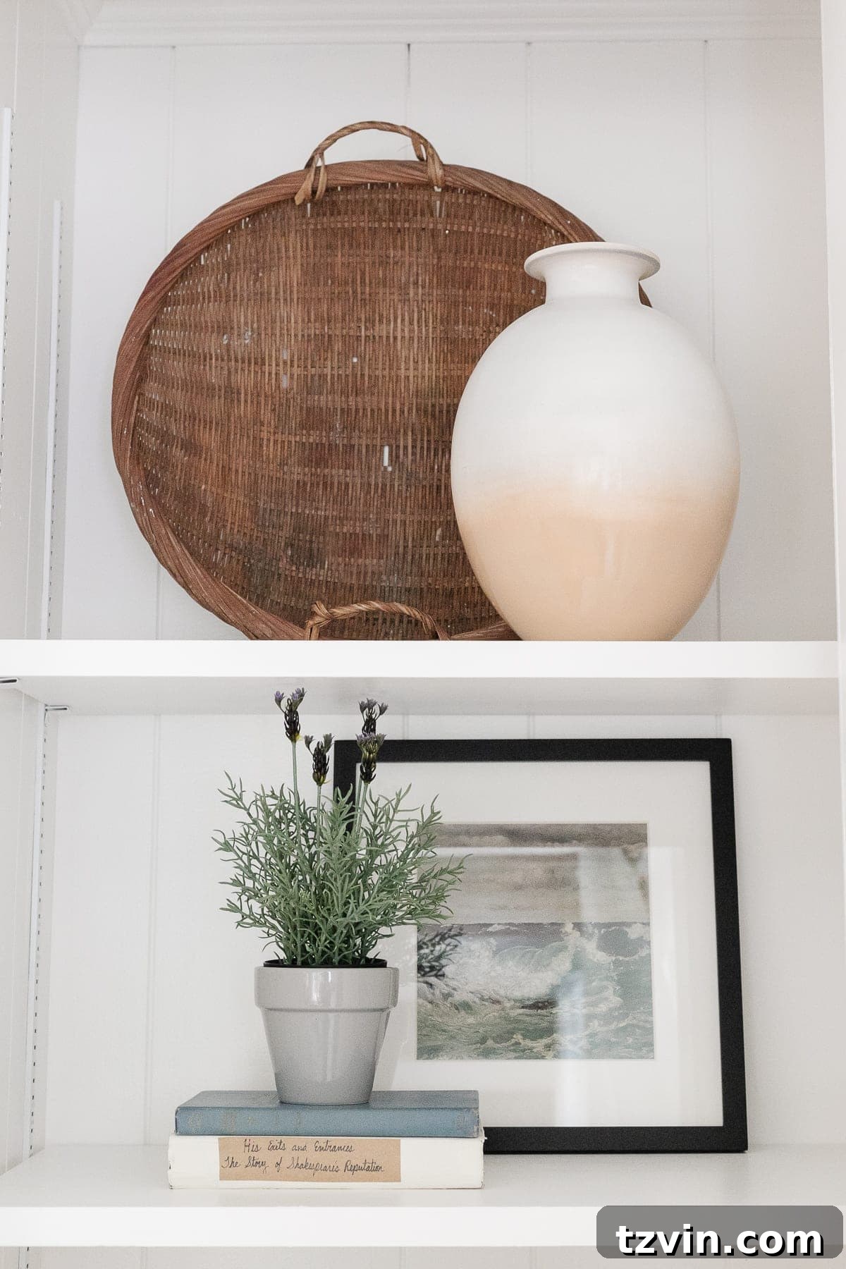 McNay Project Modern Coastal Living Room Tour 21 Styled built-in shelves with antique baskets, urns, and framed coastal art printables.