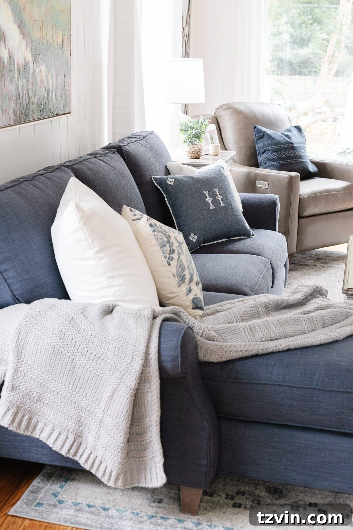 McNay Project Modern Coastal Living Room Tour 9 Detailed view of the Bassett sectional sofa with decorative pillows and a cozy blanket.