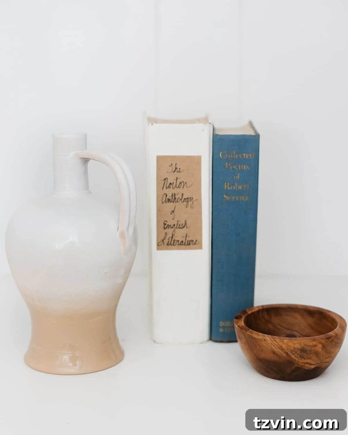 Close-up of rustic shelf decor with vases, books, and natural objects