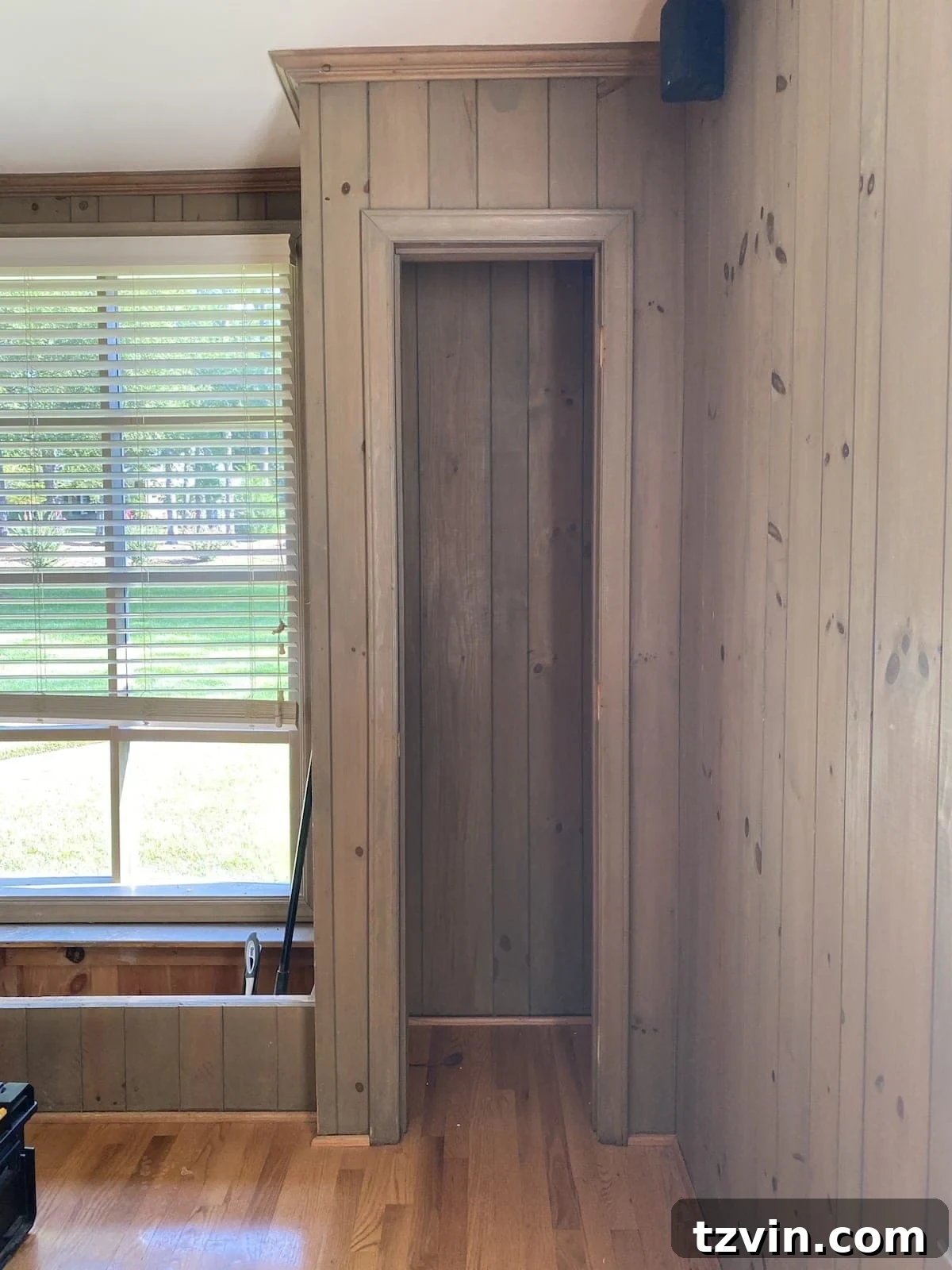 Closets with dark wood paneling and removed doors, ready for conversion