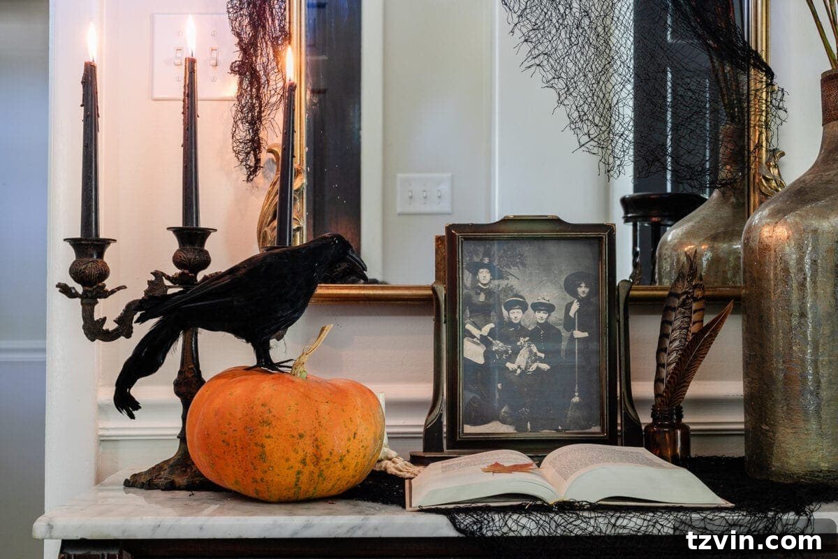 Detailed shot of an antique candelabra with flickering candles, surrounded by vintage Halloween art prints and fall decorations on a console table.