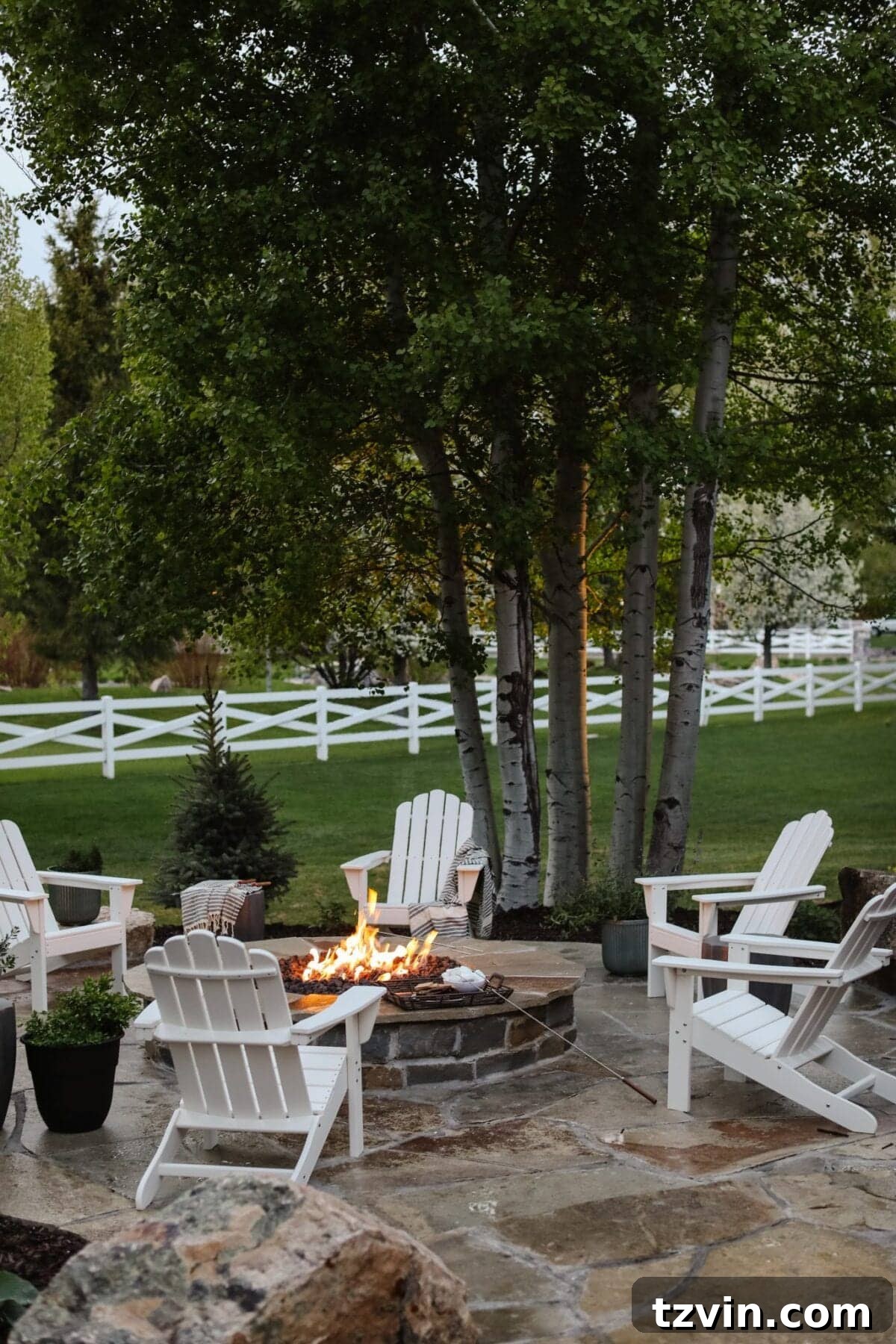 15 Mesmerizing Fire Pit Decor Transformations 11 Backyard fire pit area featuring elegant stone pavers and Adirondack chairs