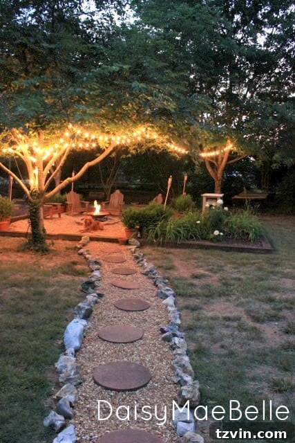 15 Mesmerizing Fire Pit Decor Transformations 12 Fire pit area illuminated by warm string lights hung from trees