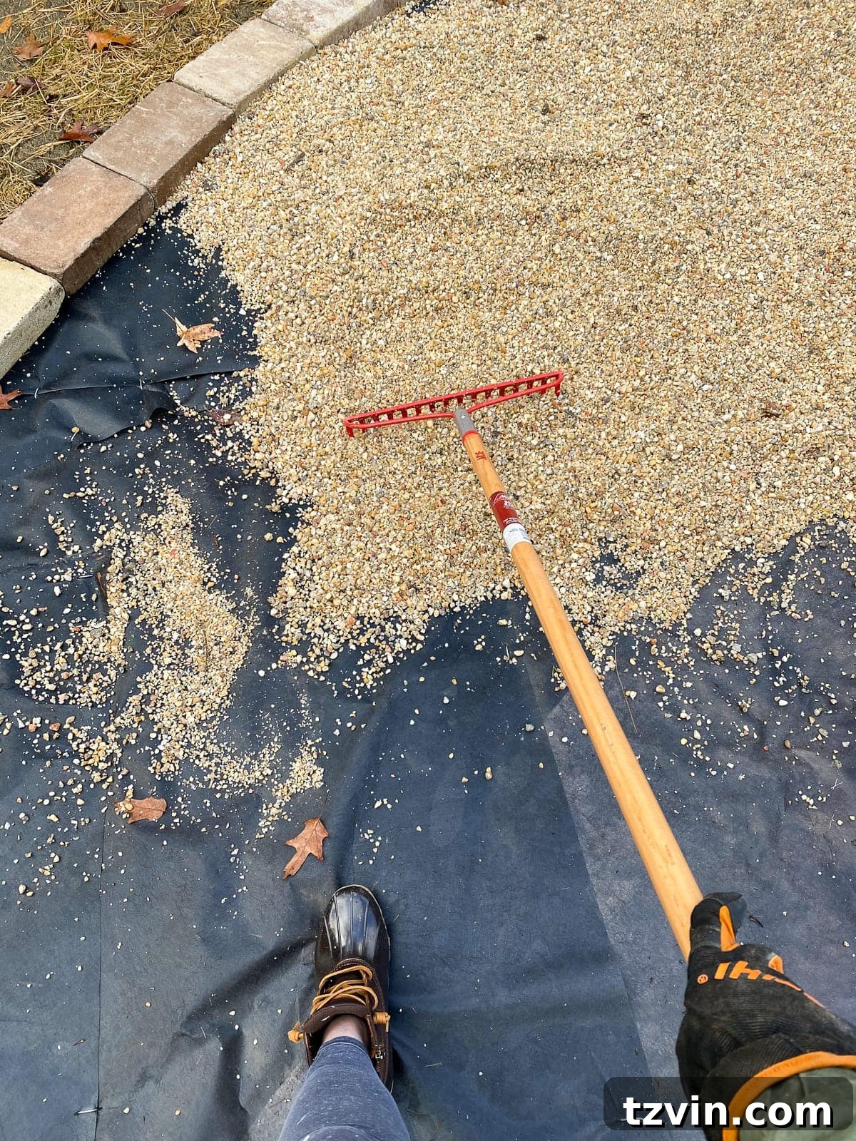 Weekend Pea Gravel Fire Pit: A DIY Build 18 Raking pea gravel on landscape fabric for a fire pit