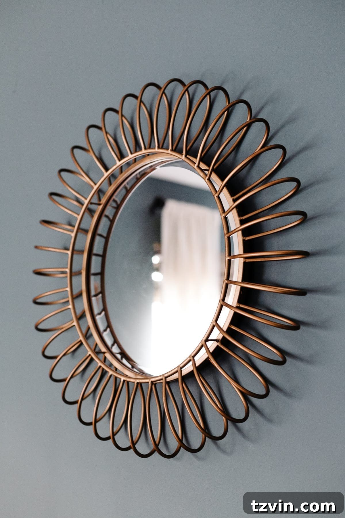Transform Your Bedroom into a Serene Spa Sanctuary 12 Gold framed round mirror above a bed in a beautifully decorated bedroom
