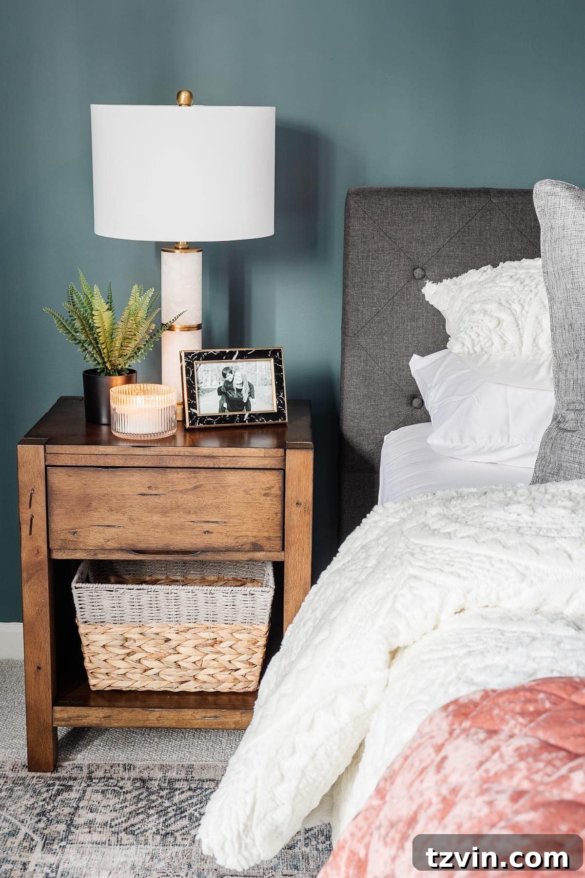 Transform Your Bedroom into a Serene Spa Sanctuary 17 Nightstand with a black marble picture frame, potted plant, and candle