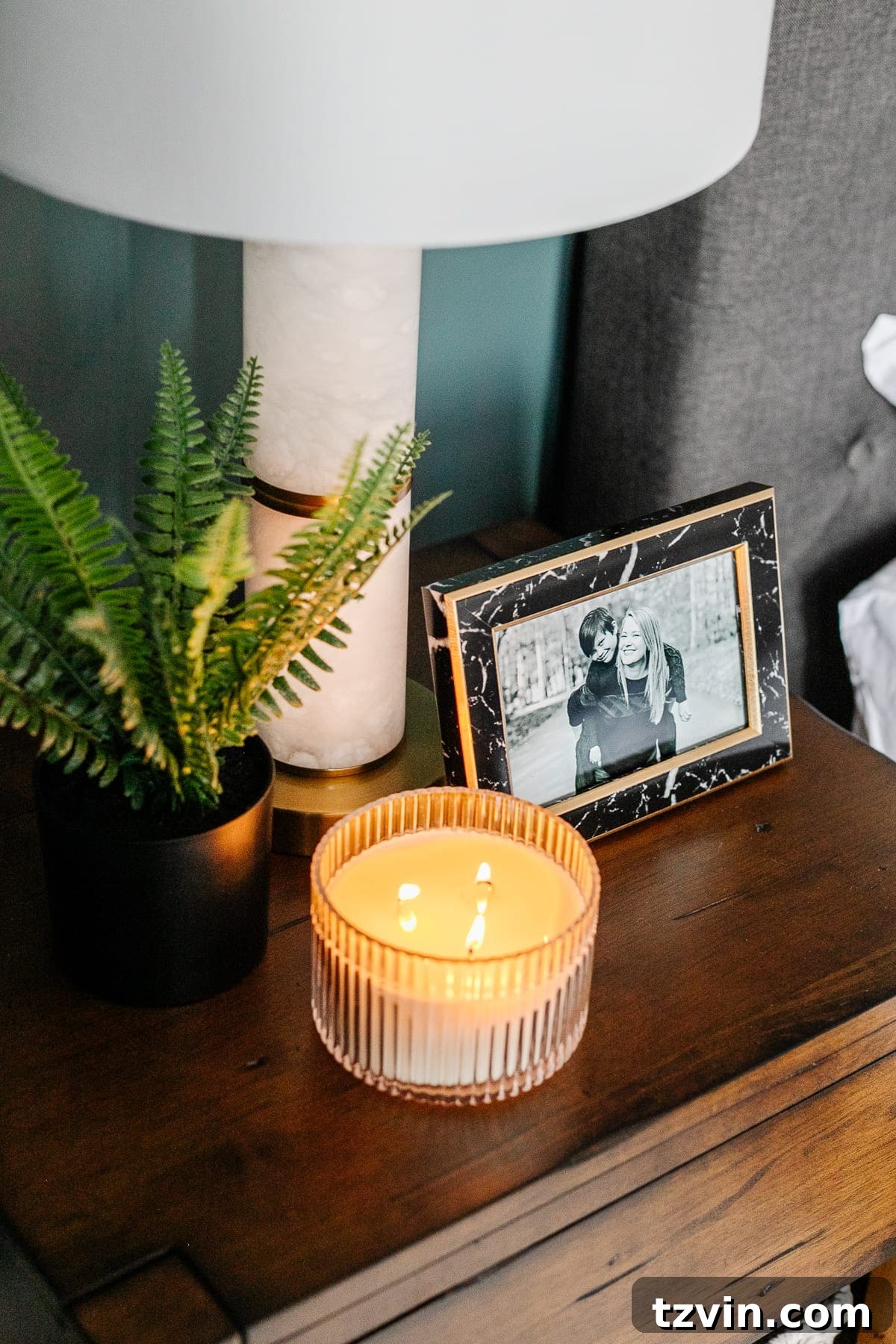 Transform Your Bedroom into a Serene Spa Sanctuary 18 Styled nightstand featuring a black marble frame, lamp, and diffuser