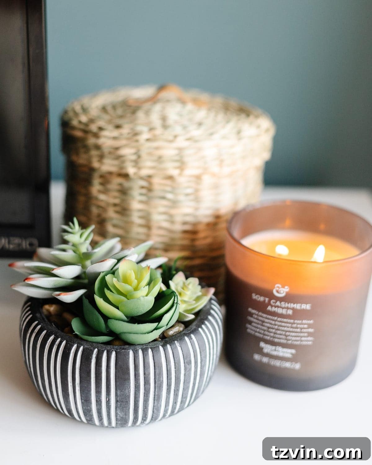 Transform Your Bedroom into a Serene Spa Sanctuary 22 Decorated dresser with succulents, candle, and woven baskets, enhancing a spa-like bedroom