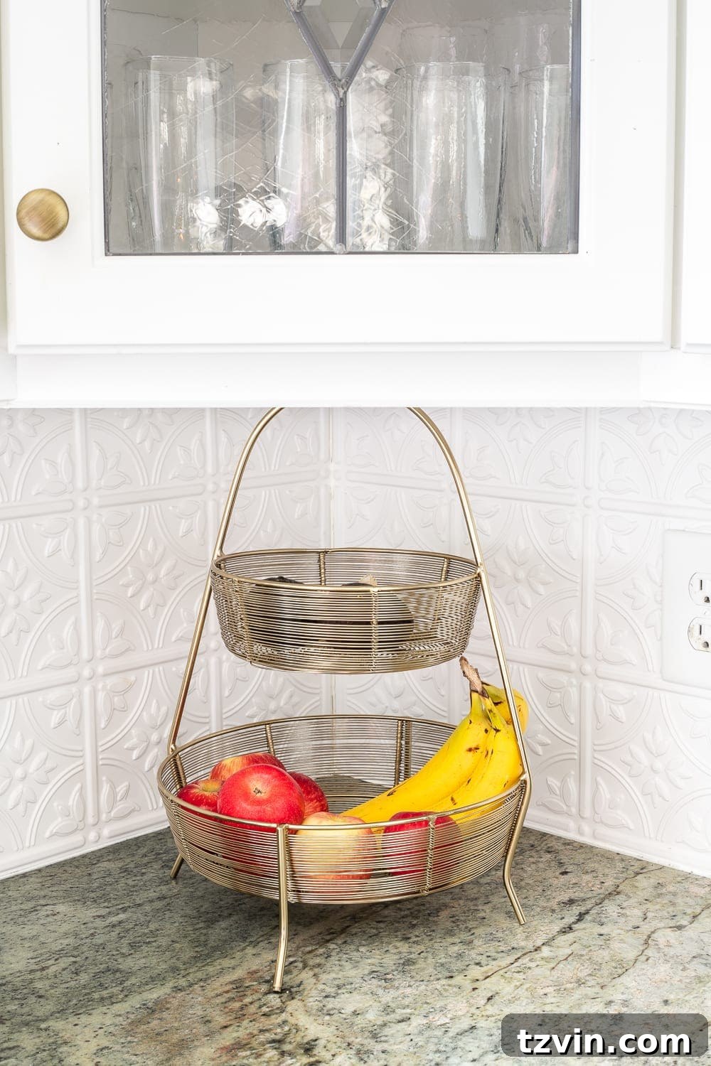 tiered basket for holding fruit on a kitchen countertop