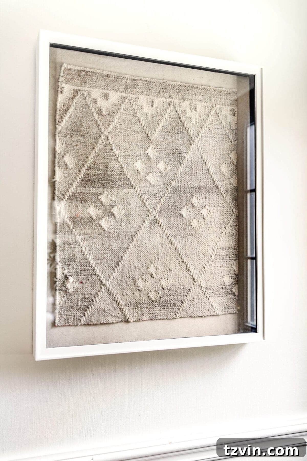 DIY Luxe Textile Art from Upcycled Rugs 2 Finished DIY designer textile art made from an old rug in a shadow box, displayed in a living room.