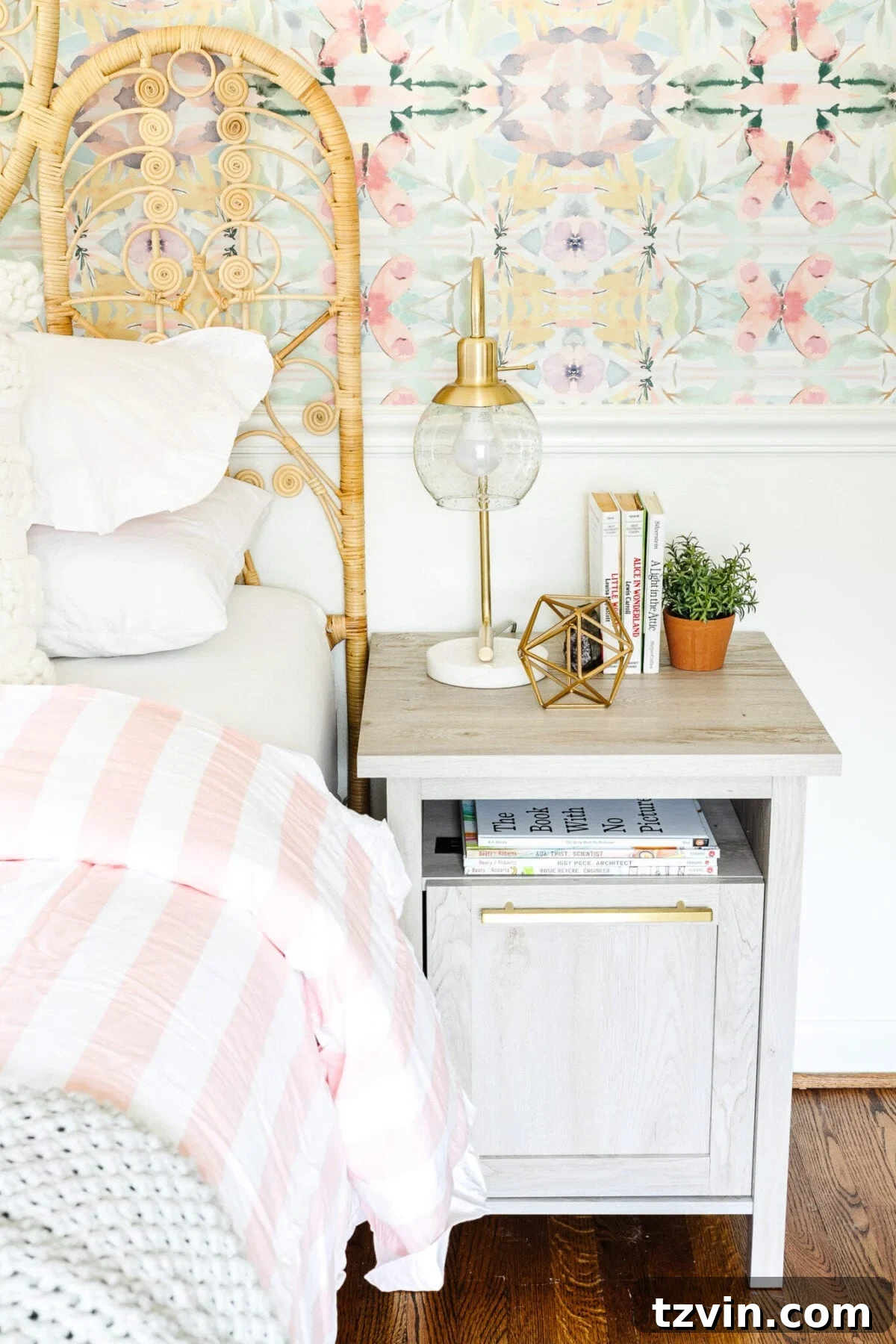 Marble and brass lamp on a nightstand with books and decor