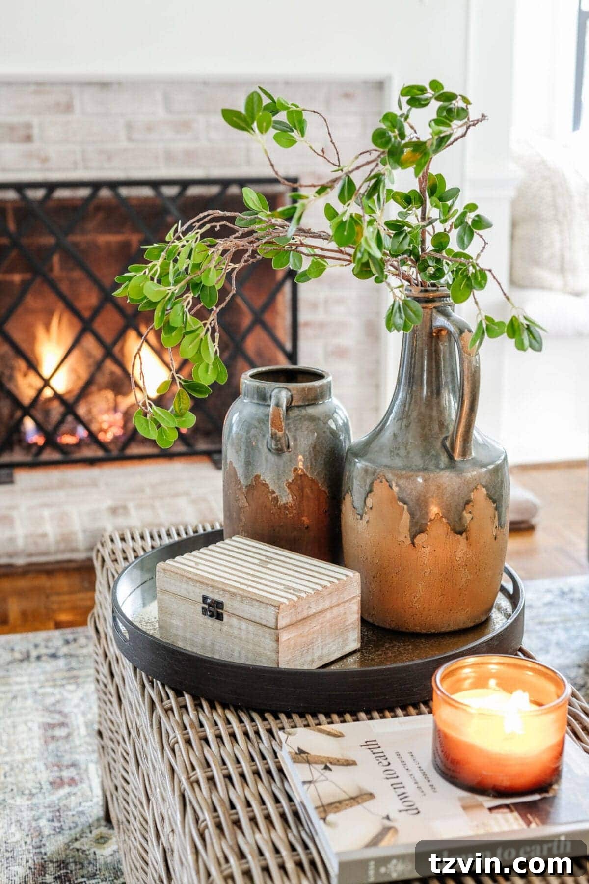 My Favorite Winter Living Room Touches 6 Coffee table styled with winter decor, featuring green branches in a vase, books, and other decorative items.