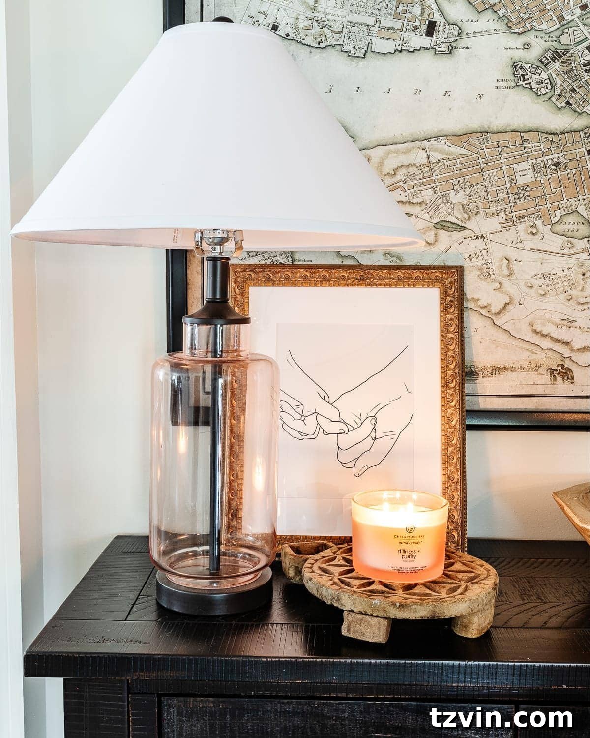 Curated Valentine's Day Elegance 5 Elegant table setting with a pink candle, art, and rattan hearts in a wooden bowl.