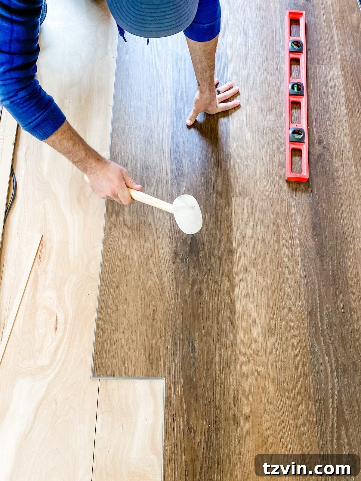 Mastering Luxury Vinyl Plank Installation 22 how to install luxury vinyl plank flooring, tapping seams with a mallet
