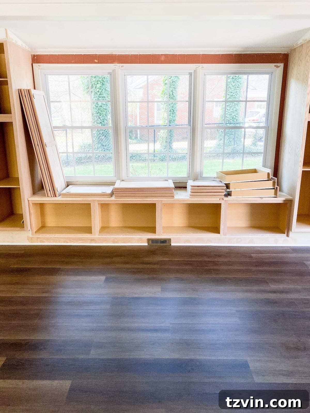 Mastering Luxury Vinyl Plank Installation 29 luxury vinyl plank flooring with DIY built-in cabinets and window seat installed