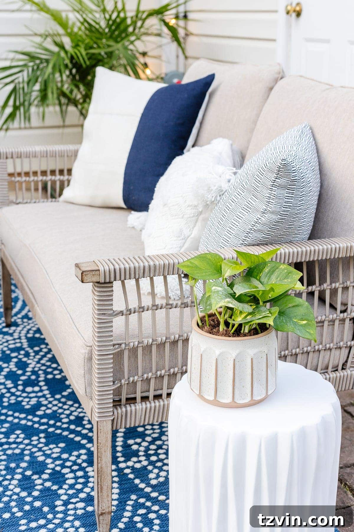 outdoor sofa with pillows and plants