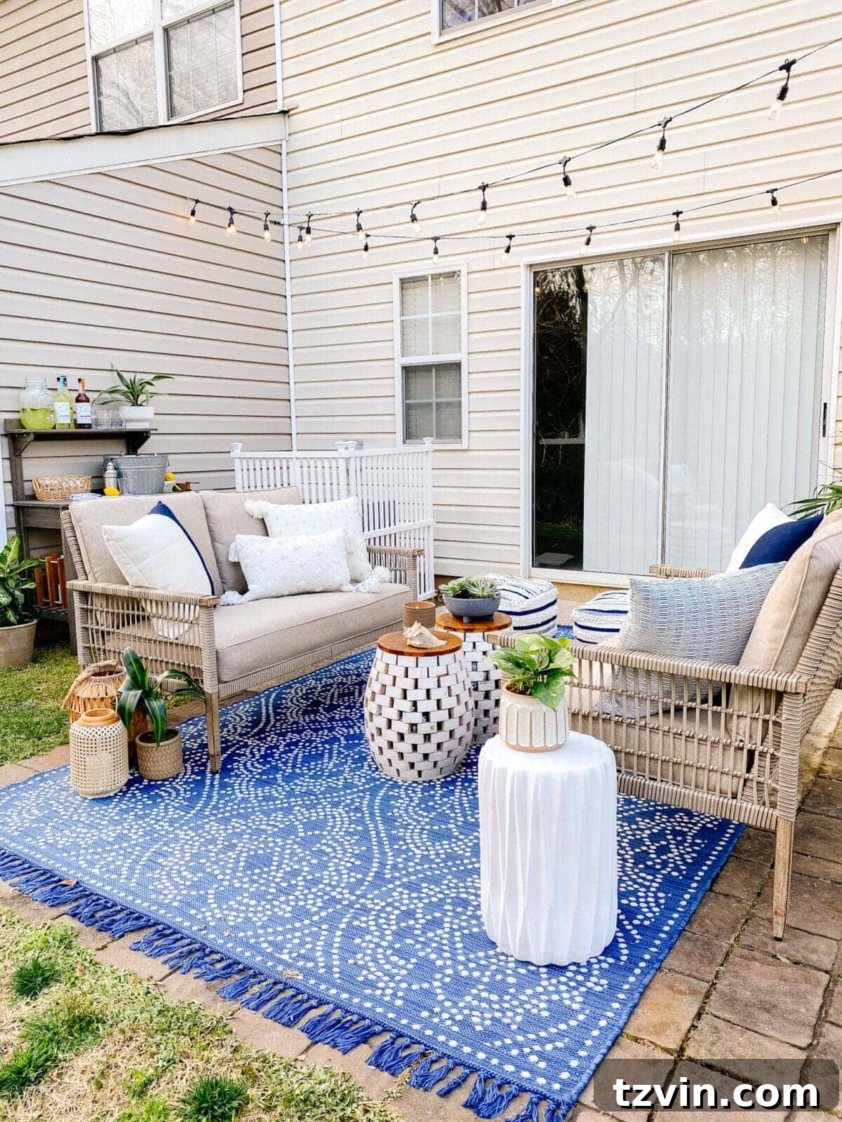 renter friendly patio ideas on a budget using outdoor sofas, garden bench as a beverage station, and string lights