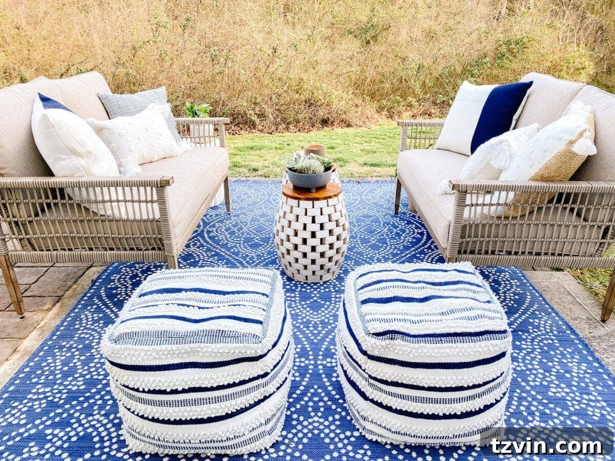 outdoor poufs and rug covering a small patio