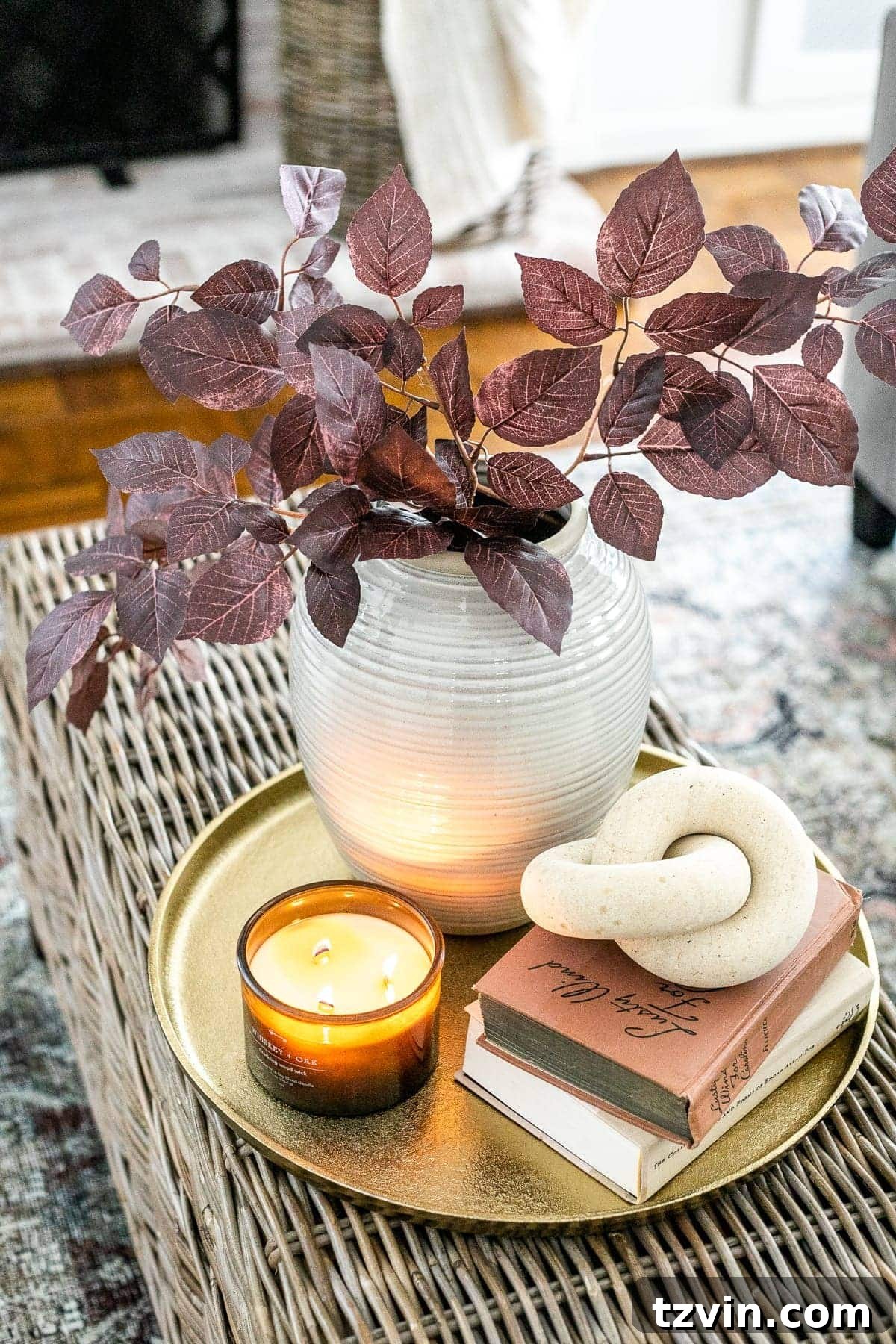 Here's the original title, followed by a single, unique, and engaging alternative: Original: Easy Coffee Table Decor Ideas and How to Style Them Alternative: Coffee Table Chic: Simple Styling Secrets 16 fall living room coffee table idea with brass tray, leaves in a vase, wooden knot, and candle