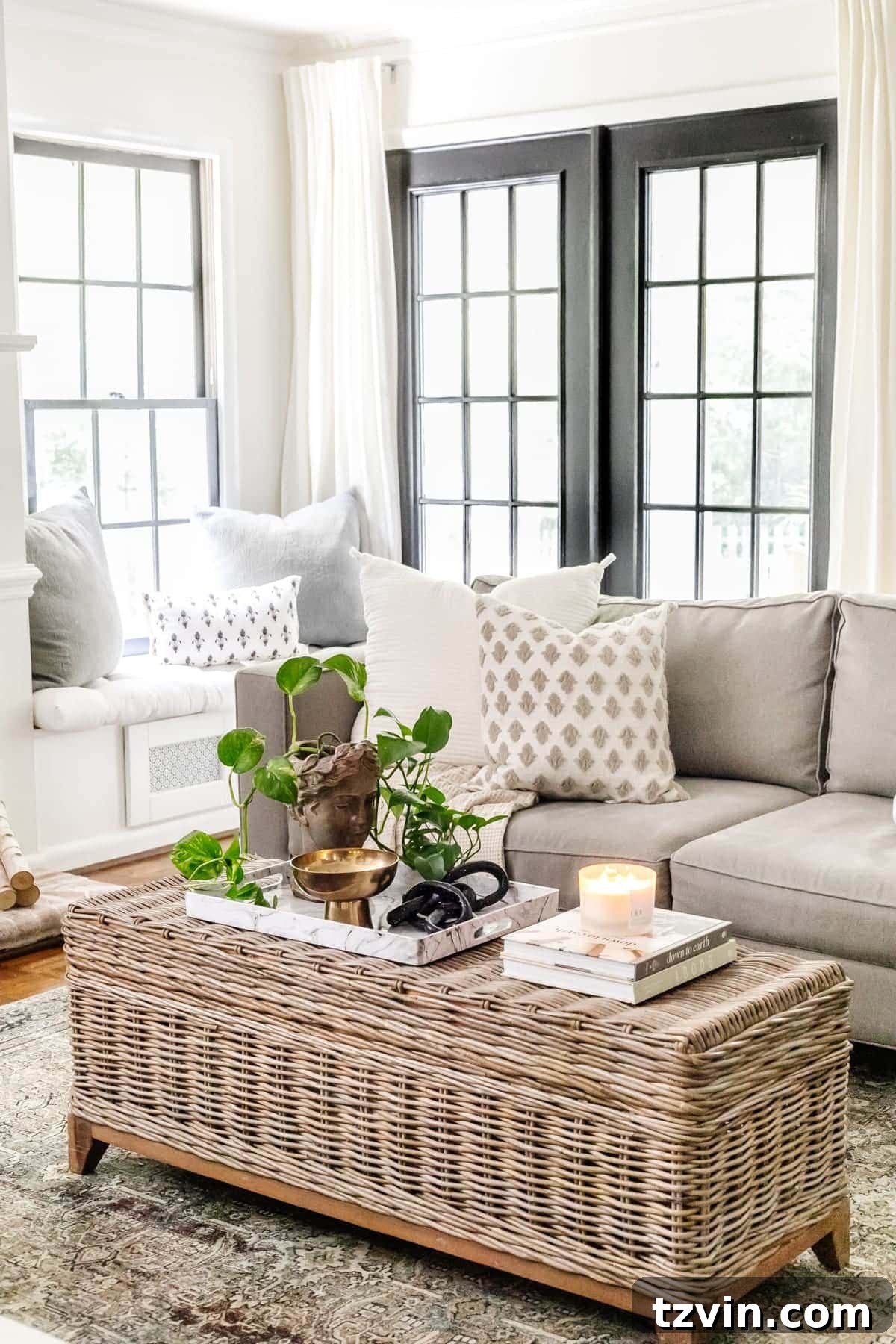 Here's the original title, followed by a single, unique, and engaging alternative: Original: Easy Coffee Table Decor Ideas and How to Style Them Alternative: Coffee Table Chic: Simple Styling Secrets 4 rattan coffee table in a living room with black doors, bust planter, and marble tray