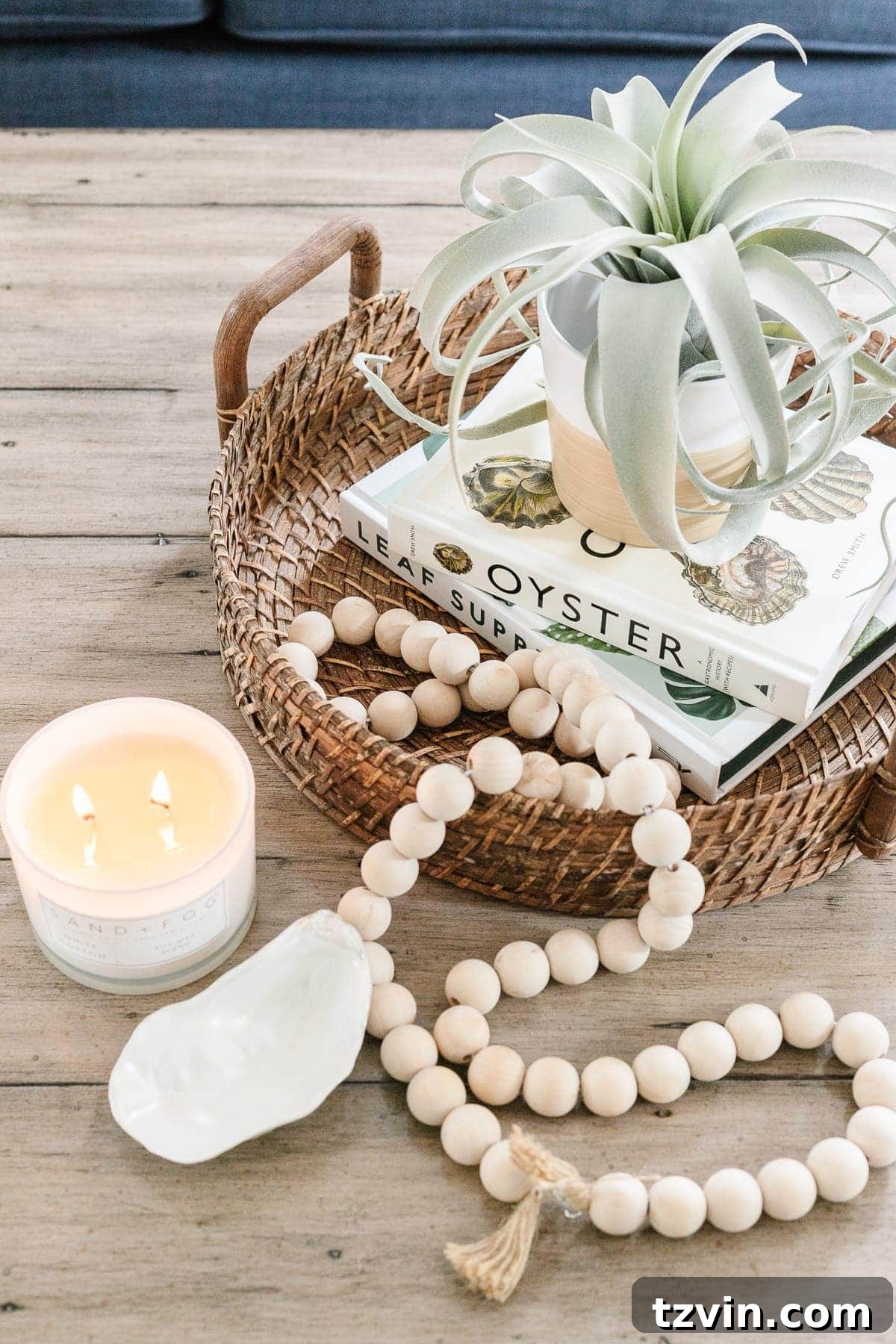 Here's the original title, followed by a single, unique, and engaging alternative: Original: Easy Coffee Table Decor Ideas and How to Style Them Alternative: Coffee Table Chic: Simple Styling Secrets 5 coastal style coffee table decor with rattan tray, wooden beads, coffee table books, candle and air plant