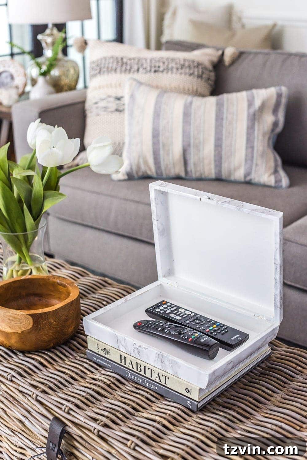 Here's the original title, followed by a single, unique, and engaging alternative: Original: Easy Coffee Table Decor Ideas and How to Style Them Alternative: Coffee Table Chic: Simple Styling Secrets 6 marble remote control holder on a coffee table for practical coffee table decor ideas