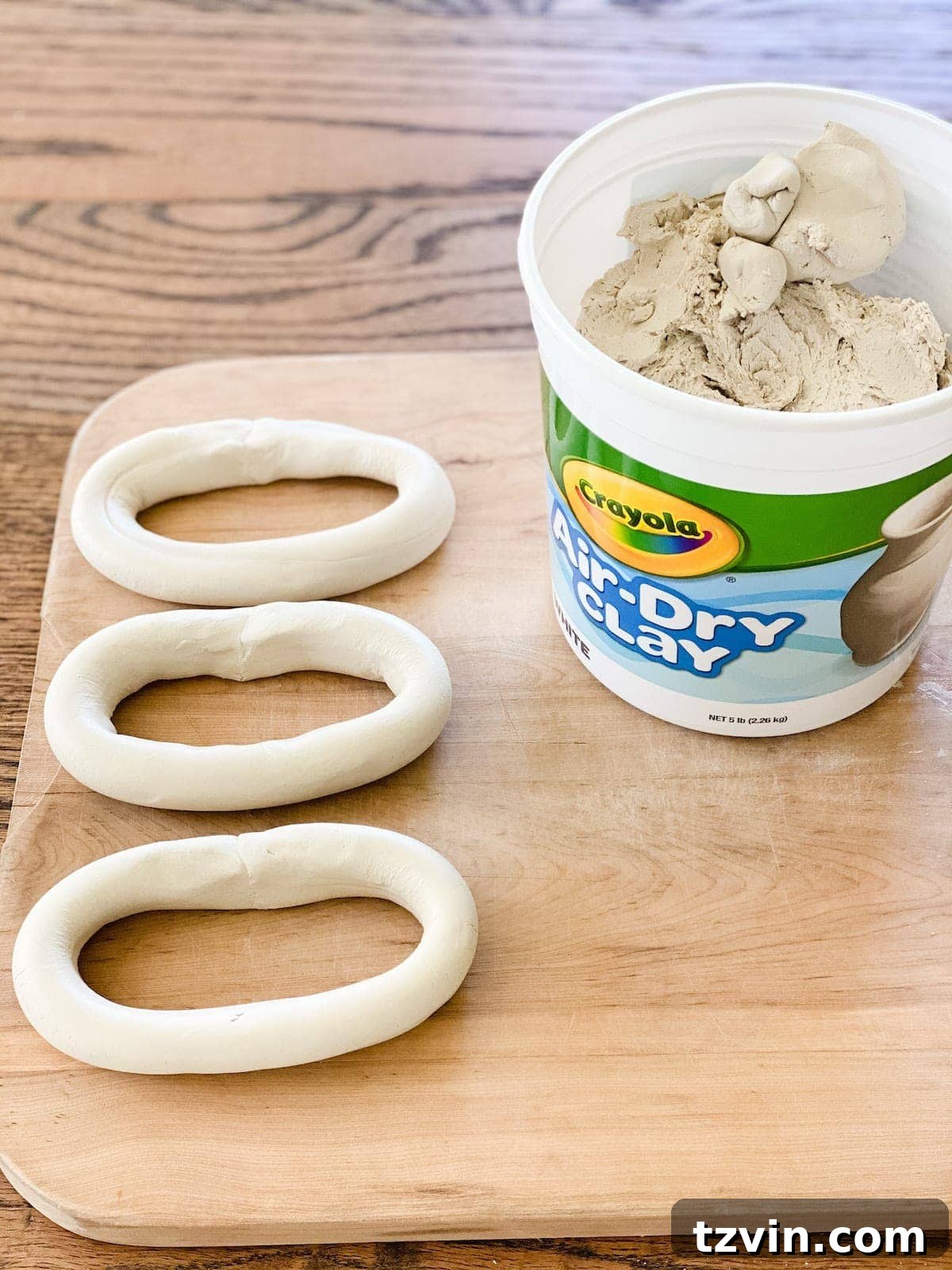 Create Decorative Chains from Air Dry Clay 5 Three individual oval-shaped links made from air dry clay, laid out to dry before assembly into a chain.