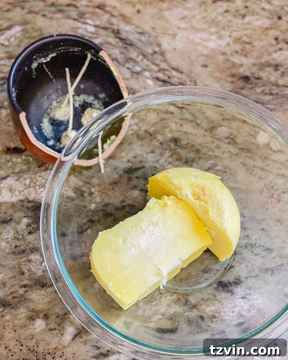 Soy wax flakes melting in a double boiler, transforming into liquid wax for DIY candle making.
