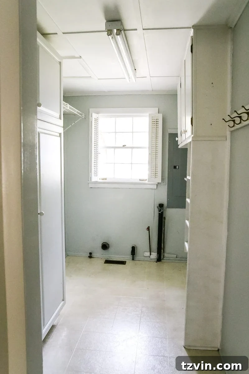 Before shot of a disorganized and uninspired laundry room.