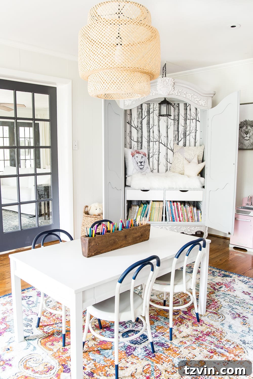 Playroom featuring a Narnia-inspired reading nook made from a thrifted wardrobe, creating a whimsical and cozy space for reading.