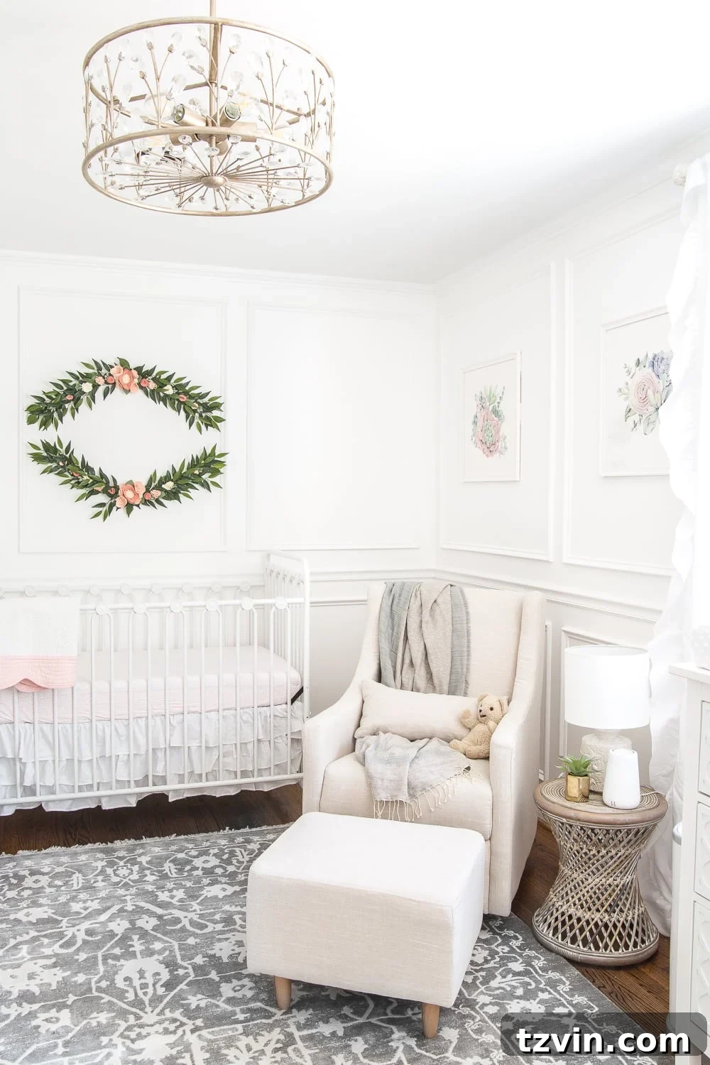 Regan's nursery featuring Magnolia Home True White paint, DIY picture frame molding, and refinished hardwood floors.