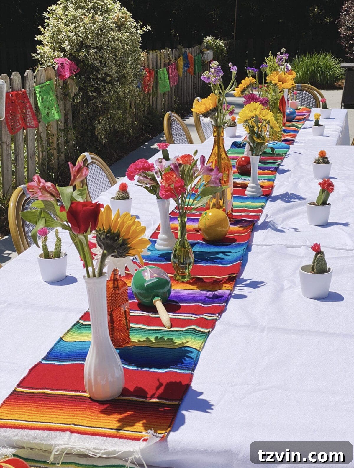 Make Your Baby Shower a Fiesta to Remember 4 Serape table runner with Mexican flowers, maracas, and baby cacti party favors