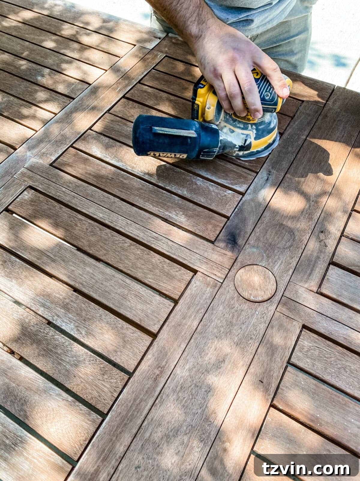 Craft Your Own Driftwood Style Outdoor Dining Table 3 Sanding an old outdoor table to prepare for painting