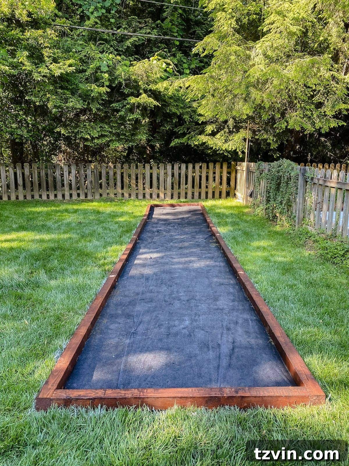 completed bocce ball court frame with weed fabric base