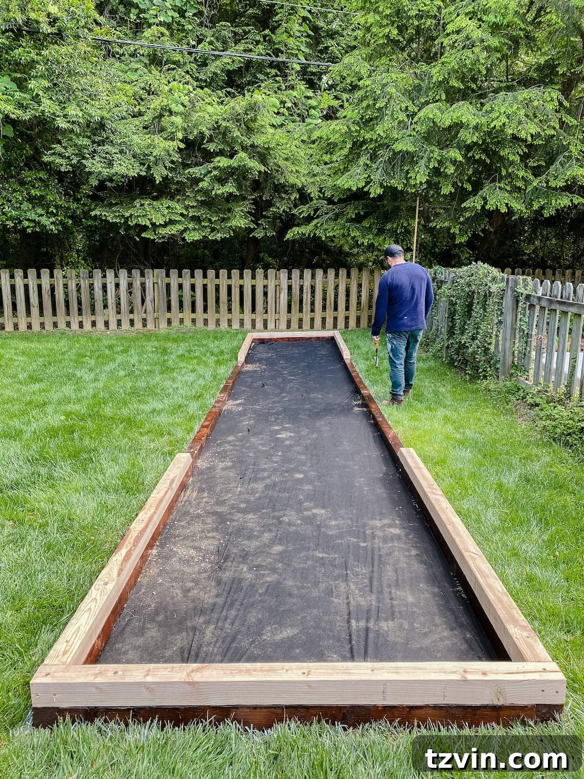 adding second layer of wood boards to bocce court frame