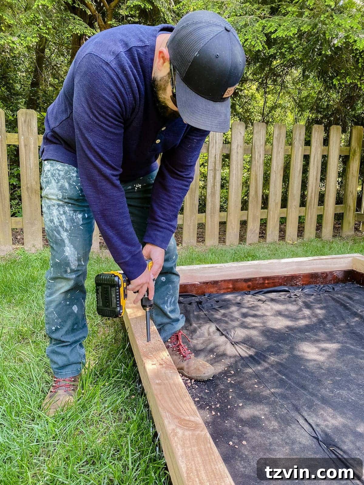 drilling pilot holes for rebar in bocce court frame