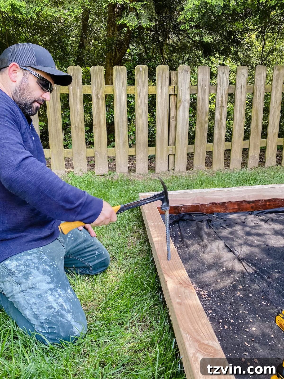 driving rebar spikes into bocce ball court frame