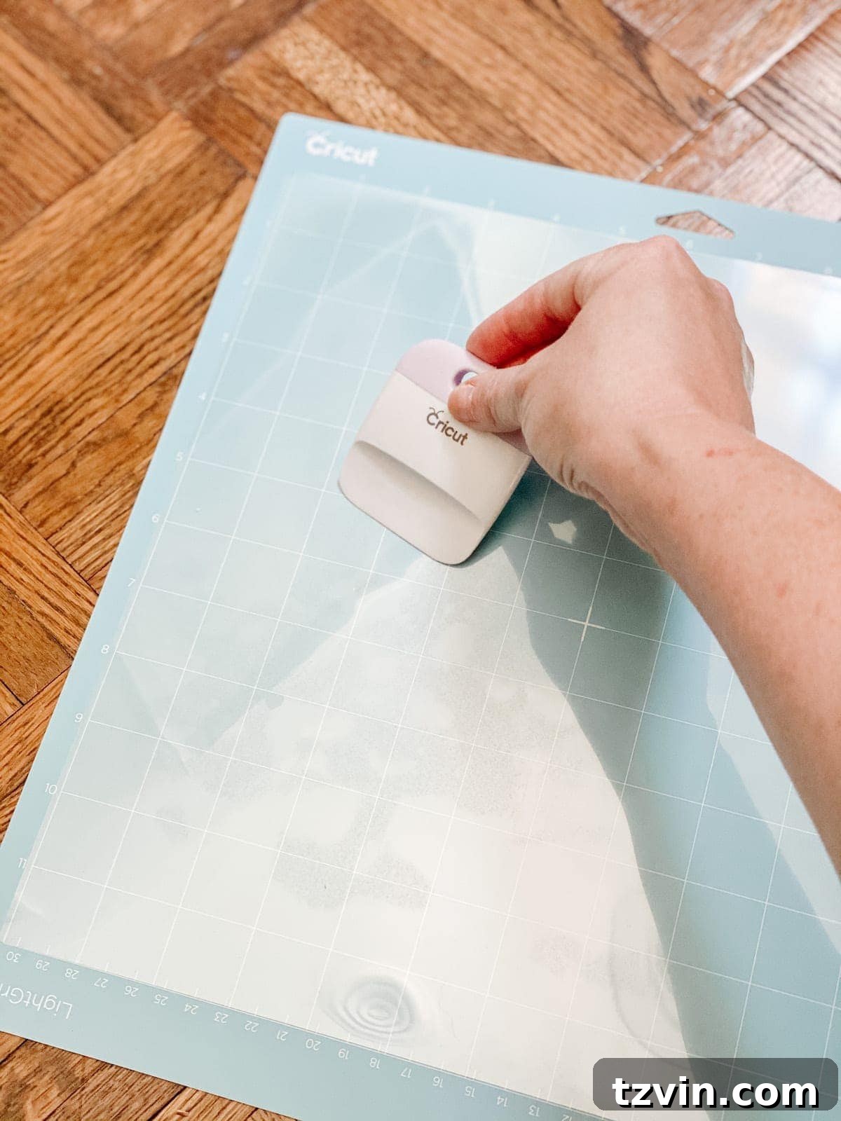 Placing acetate sheet on Cricut mat and loading into machine
