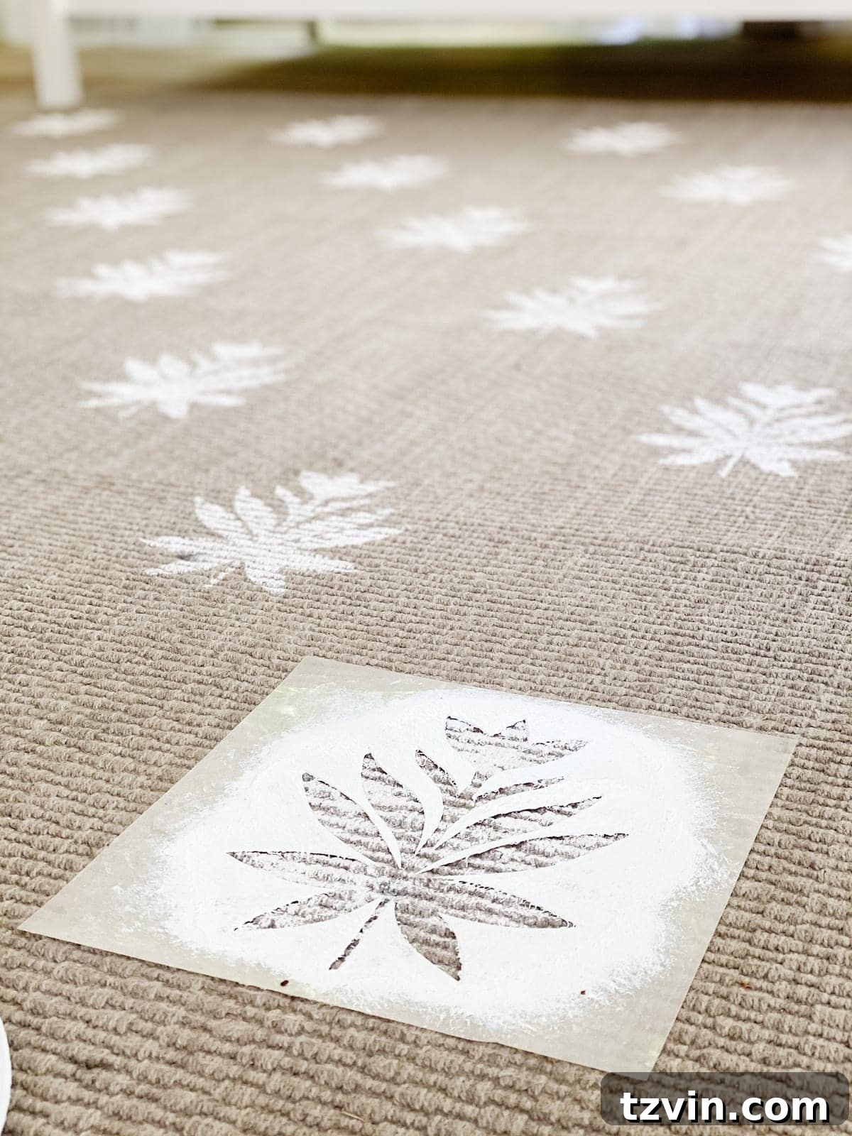 DIY outdoor rug with floral block pattern using a homemade stencil