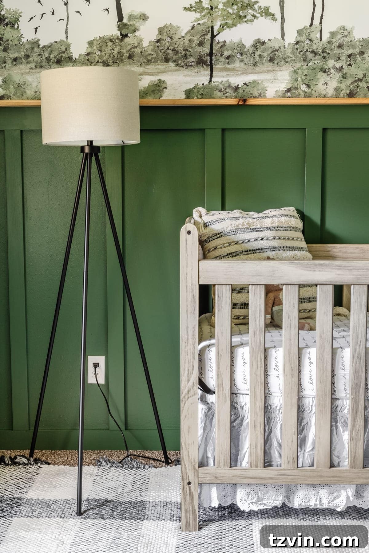 Our Cozy Woodland Wonderland: Baby Boy Nursery Transformation 15 Woodland theme baby boy nursery with floor lamp, natural wood crib, plaid rug, and wall mural